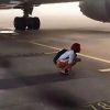 Couple miss flight, squat under plane with luggage to prevent it from taking off