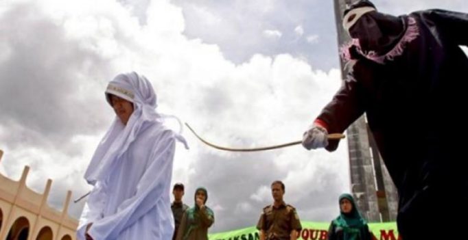 Woman caned in front of jeering crowd in Indonesia for breaking Islamic law