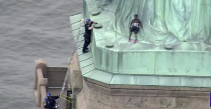 Woman protesting migrant separation climbs base of Statue of Liberty, booked